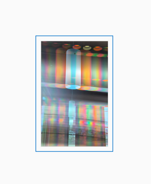 Diffraction grating photograph of a vintage pendant light fixture in a Taco Bell restaurant, rendered with rainbow spectral color.