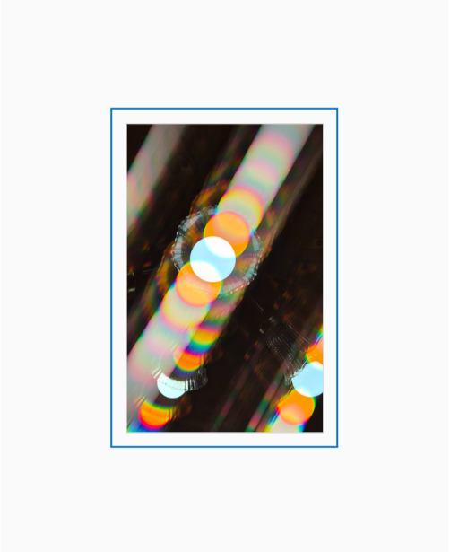 Diffraction grating photograph of a ceiling fan in a home interior, rendered with rainbow color streaks.
