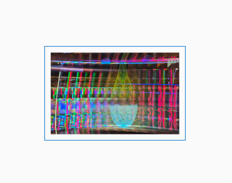 Diffraction grating photograph of a decorative casino wall, lit from behind, rendered with rich spectral color across architectural detail.