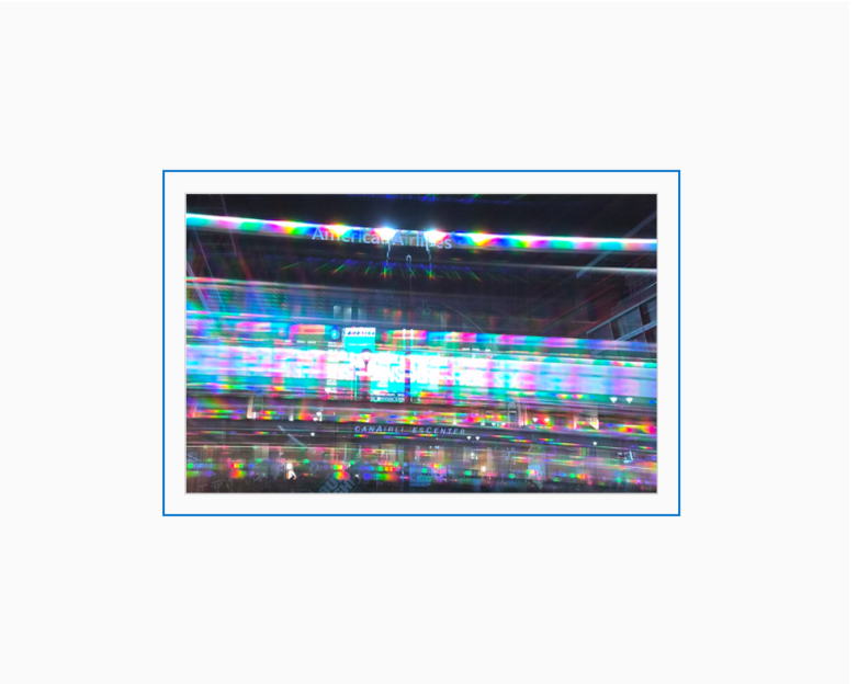 Diffraction grating photograph taken at the American Airlines Center in Dallas, rendered in spectral rainbow light.