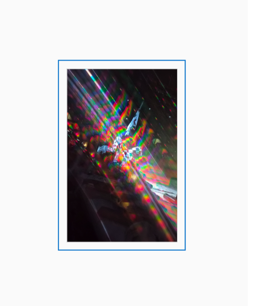 Diffraction grating photograph of a knight on horseback at Medieval Times Dallas, surrounded by streaks of rainbow color against a dark arena background.