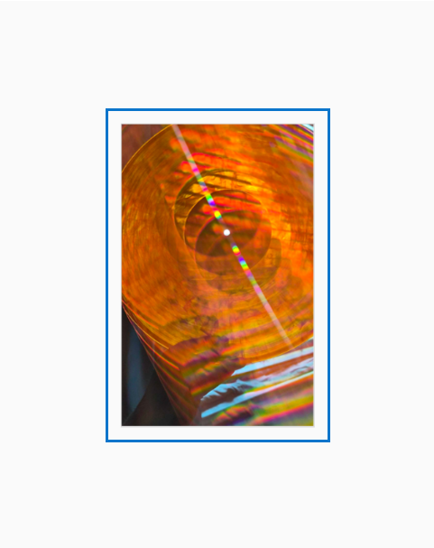 Diffraction grating photo of an orange vinyl record.