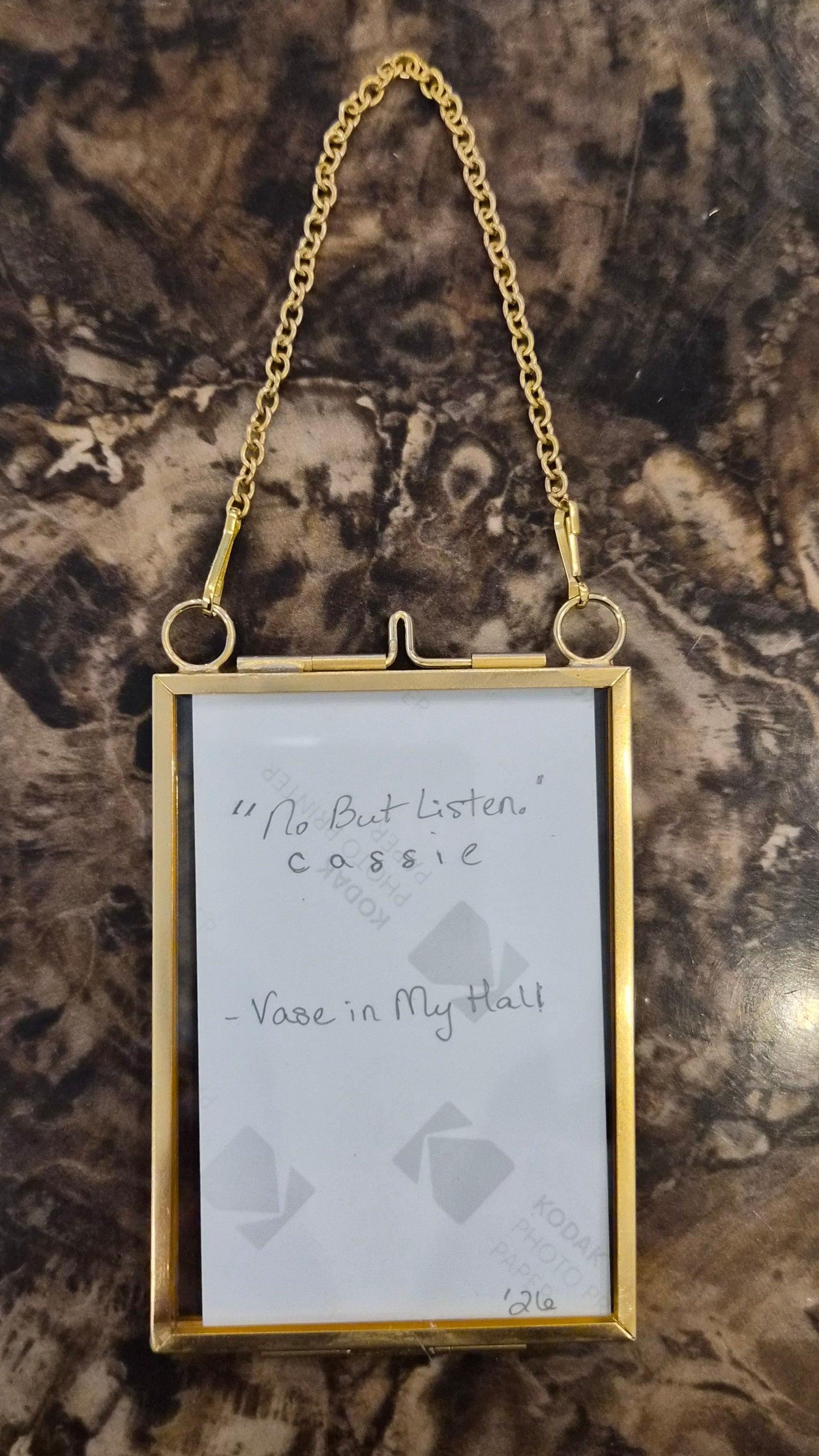 Art print in a gold locket frame