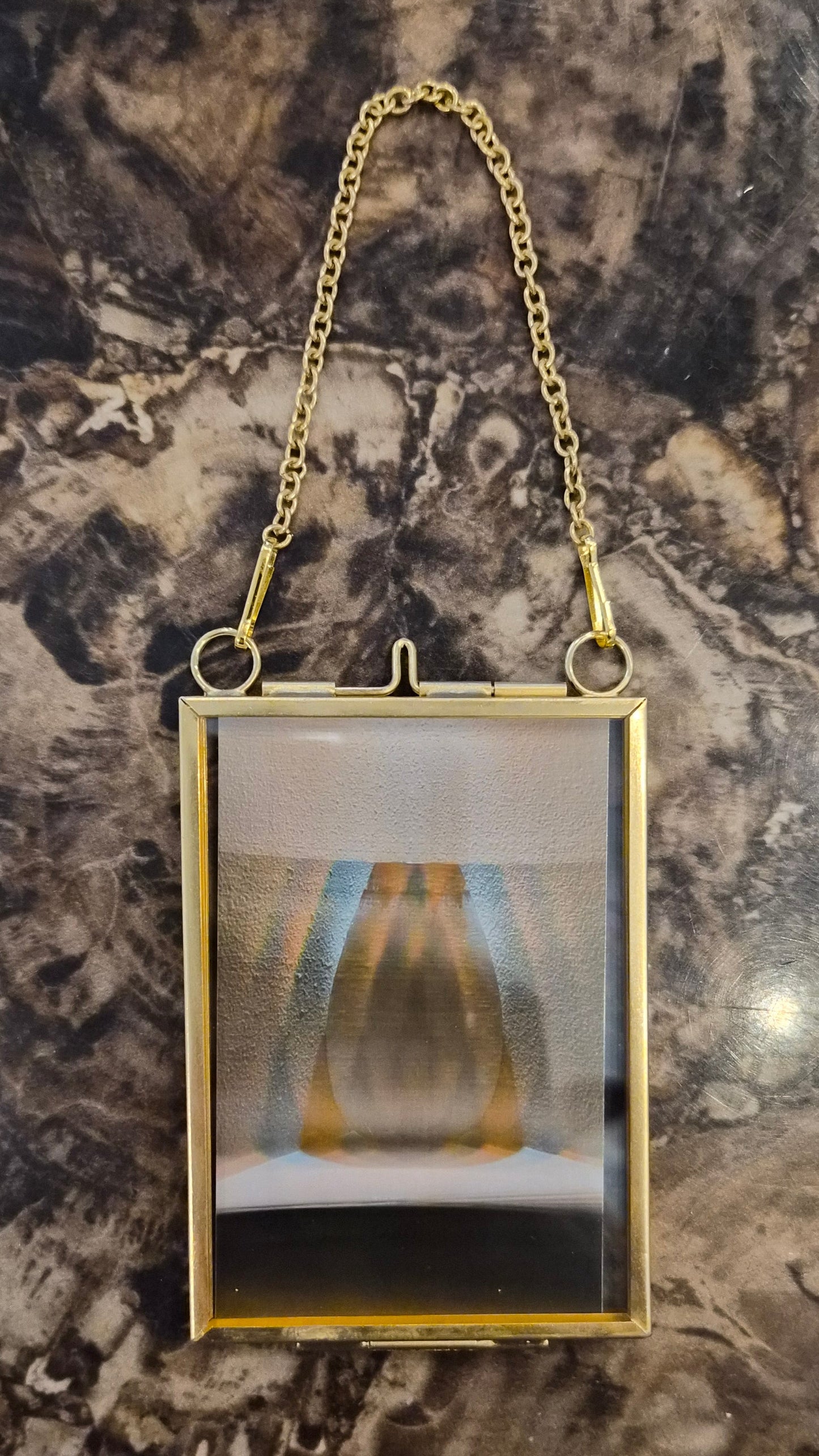 Art print in a gold locket frame
